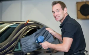 Professional car wrap installation using carbon fibre vinyl, demonstrating how vinyl car wraps are applied to vehicle panels in the UK