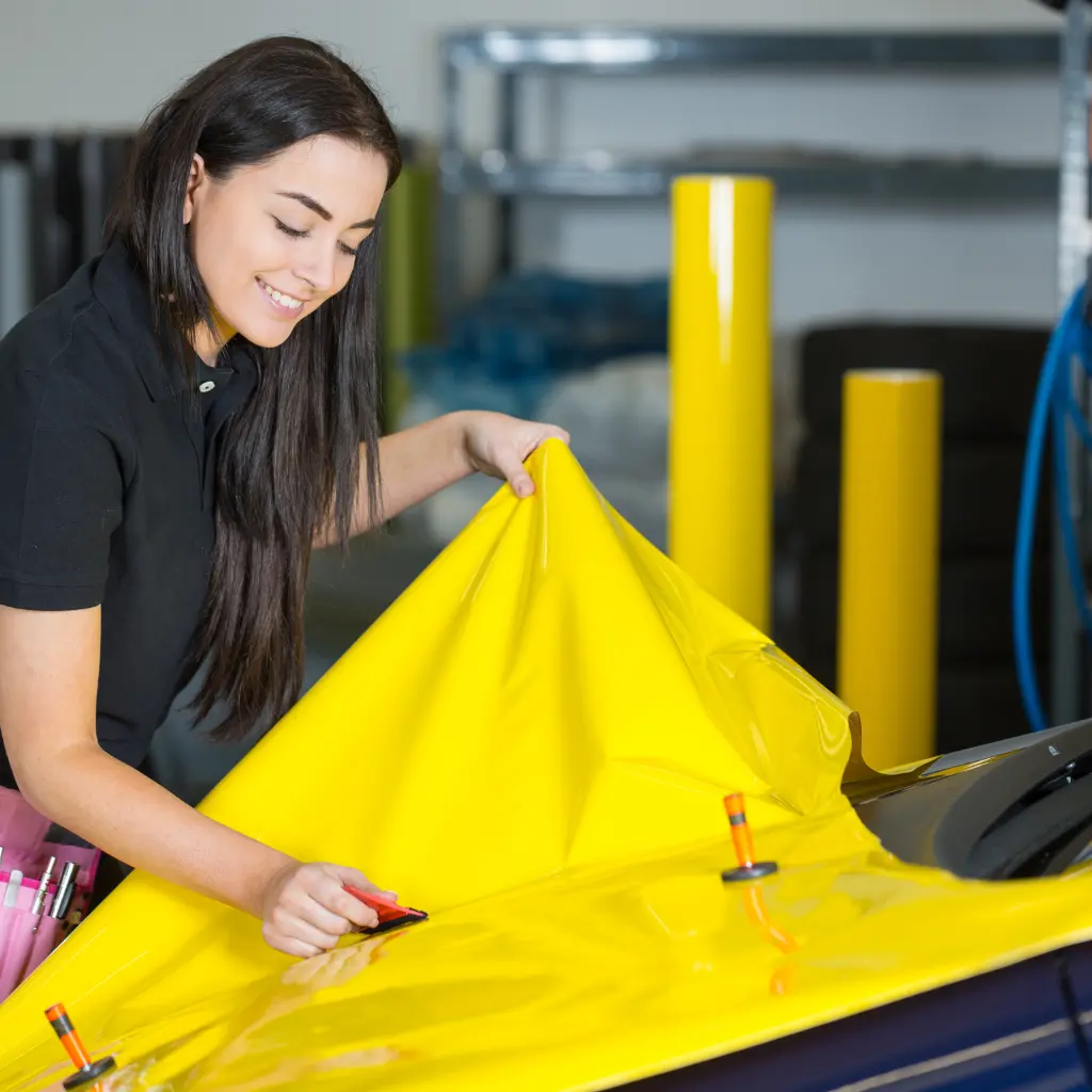 Full car wrap application in progress with gloss vinyl, showcasing colour change car wrap installation in a UK workshop
