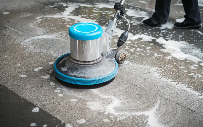 Floor graphics installation preparation showing industrial cleaning machine on concrete surface before vinyl application