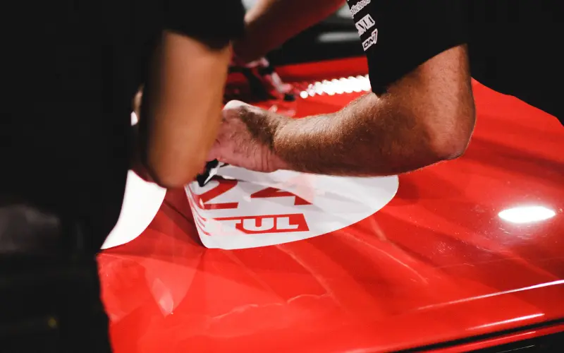 How to Put Car Decals On: A Step-by-Step Guide 1 Professional car decal installation on vehicle bonnet, demonstrating step by step vinyl decal application process