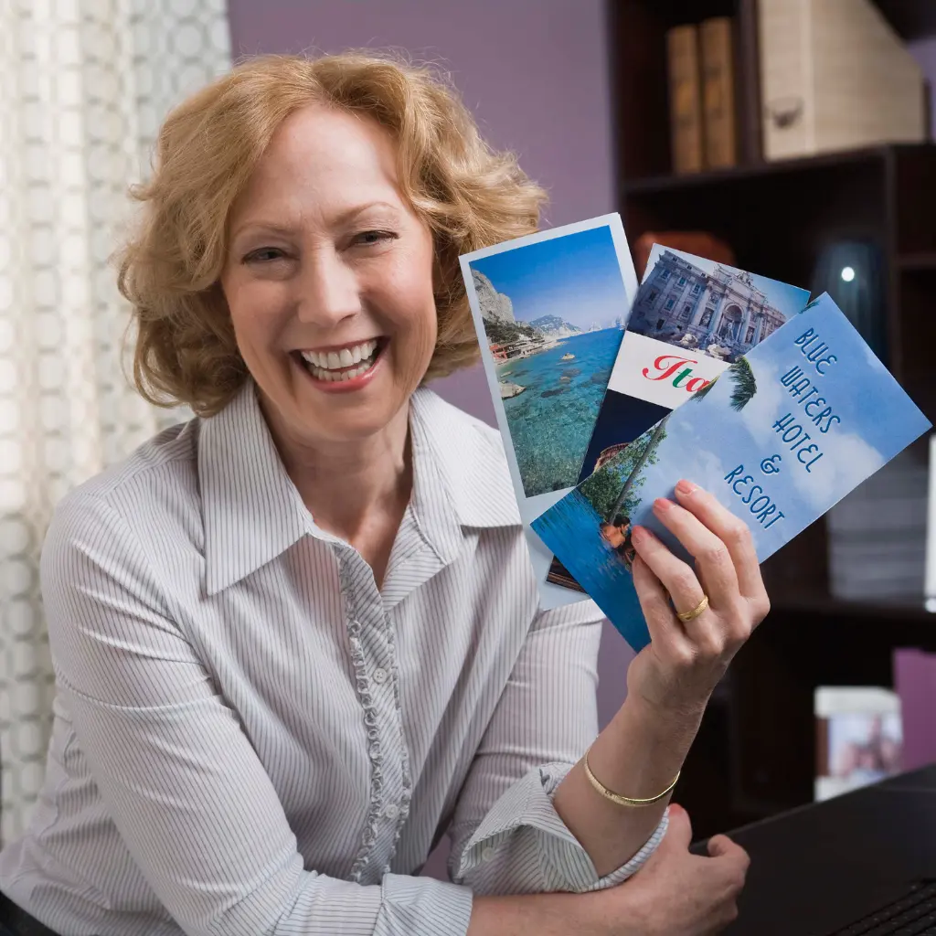 Person holding a selection of printed brochures and leaflets, showing how multi-page brochures are used for detailed marketing and information.