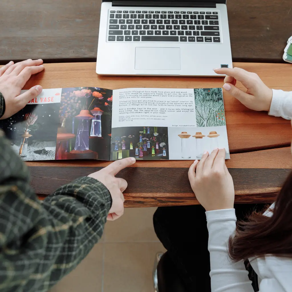 Difference between Brochures and Leaflets, and How Do They Compare to Flyers, Booklets, and Pamphlets 1 Open folded brochure design displayed on a desk, highlighting the layout difference between brochures, leaflets and printed booklets.