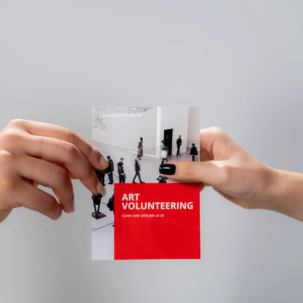 Difference Between Flyers and Brochures Explained 3 Folded brochure held in hands, showing brochure design structure and how brochures differ from flyers for detailed brand communication.