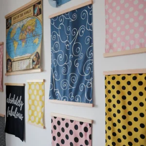 colourful custom fabric posters hung on interior wall using wooden rails for home and business display