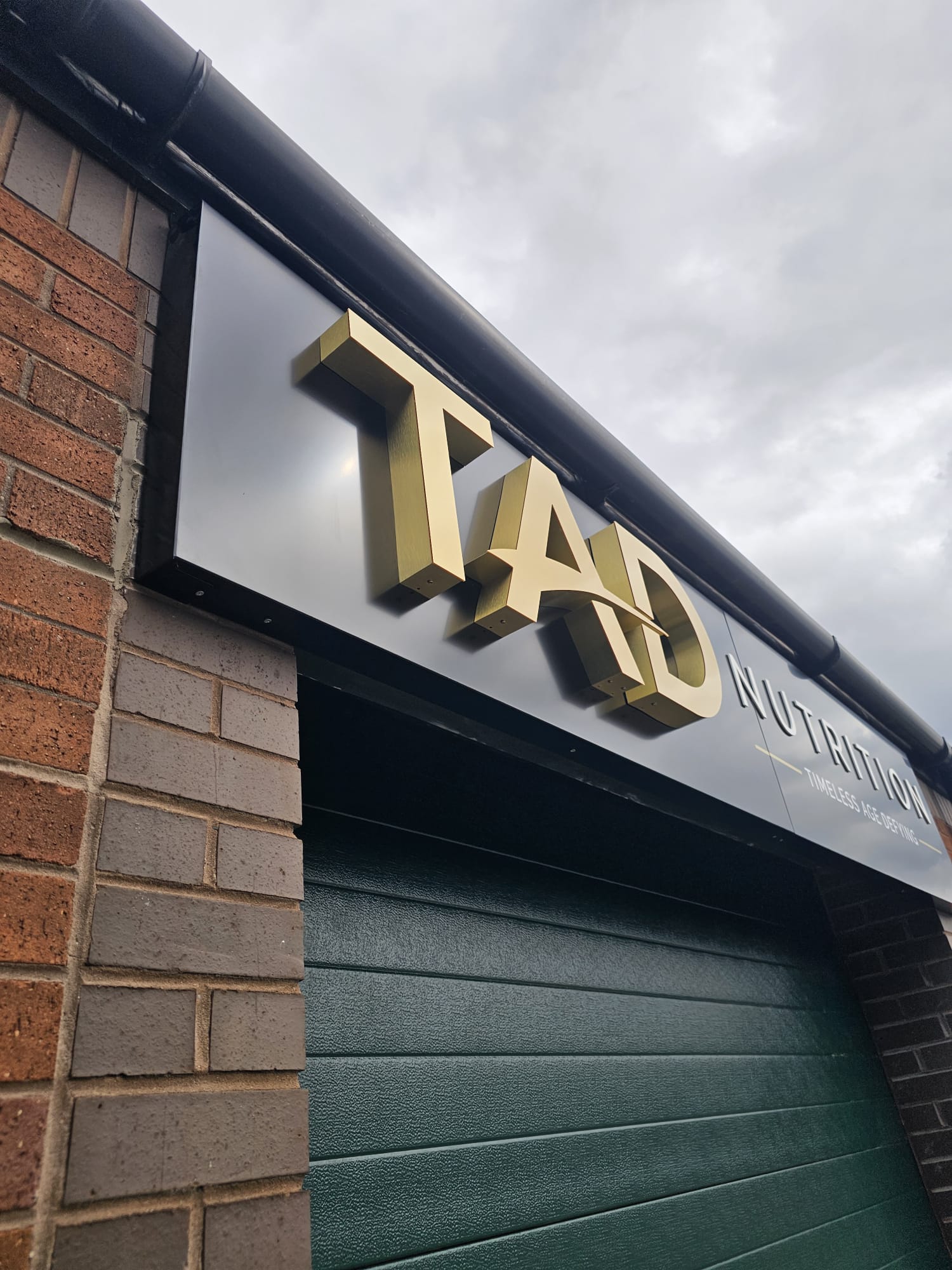 Close-up of gold built-up 3D letters standing proud of the fascia panel